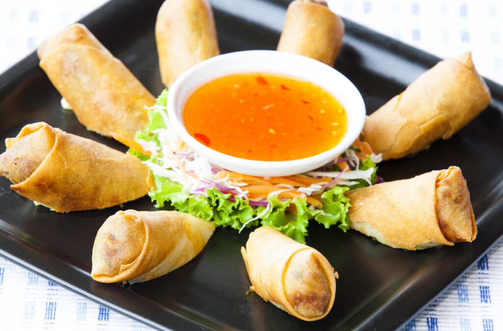 Vietnamese food menu: A plate of spring rolls with sweet chili dip sauce / Source: jee1999 - YayImages